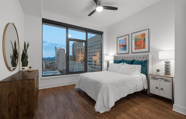 a bedroom with a large bed and a large window at Stanza Little Italy, California, 92101