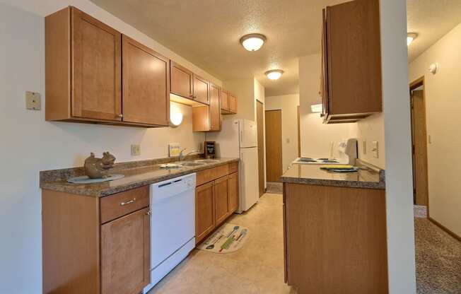 Fargo, ND Saddlebrook Apartments. A kitchen with white appliances