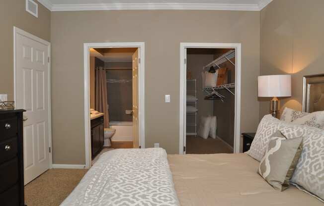 a bedroom with a bed and a closet and a bathroom