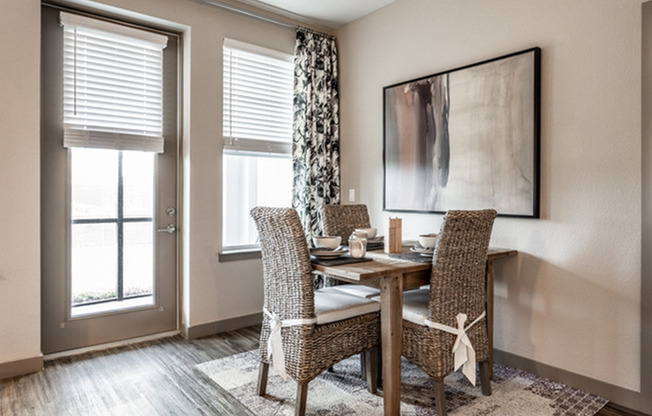 furnished dining area with table and chairs in apartment home