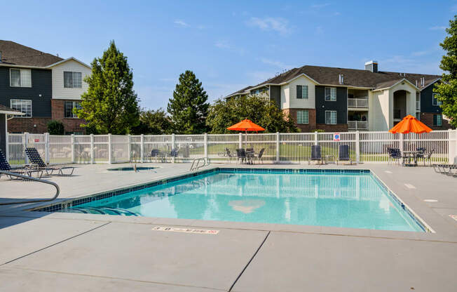 our apartments have a resort style pool with chairs and umbrellas