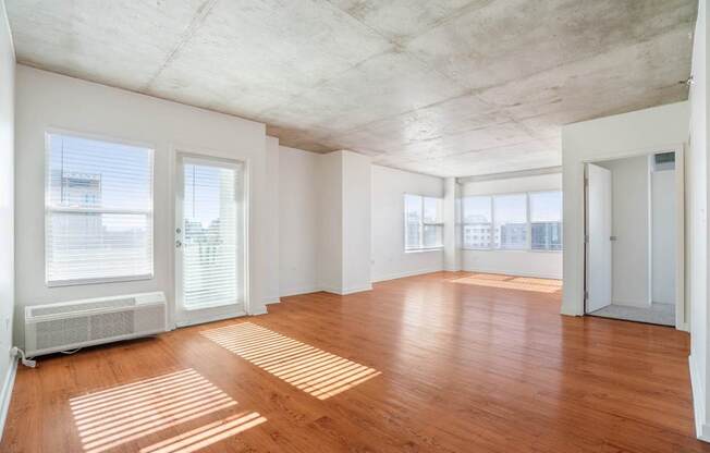 A room with wooden floors and a concrete ceiling.