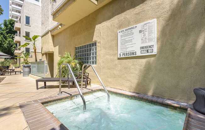 A pool with a warning sign on the wall.