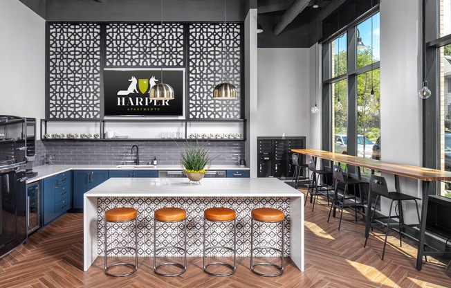 a kitchen with a large center island with stools in front of it
