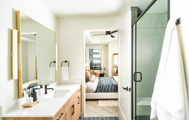 Bright and airy baths at Modera St. Paul feature sleek finishes and spacious layouts, seamlessly connecting to your restful bedroom retreat in Dallas.