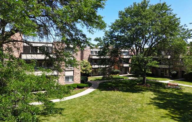 the view of an apartment building with grass and trees