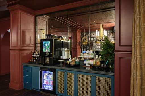 a bar with blue cabinets and a large mirror behind it at Fairfax, Grandview, Ohio