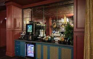 a bar with blue cabinets and a large mirror behind it at Fairfax, Grandview, Ohio