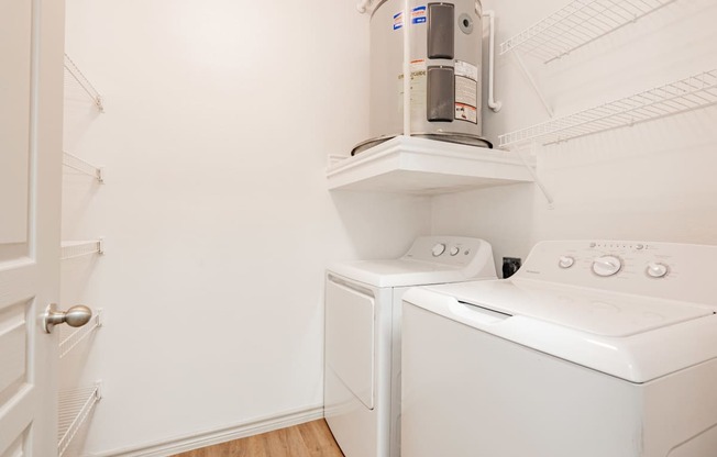 a laundry room with a washer and dryer and a coffeemaker in