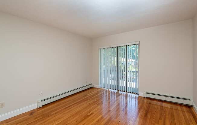 Quincy Commons one bedroom apartment with wood flooring and balcony