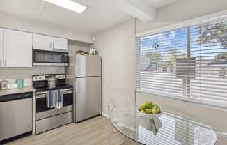 a kitchen with stainless steel appliances and a glass table