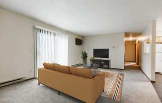 a living room with a couch and a tv  at Harrison and Richfield, Grand Forks, 58201