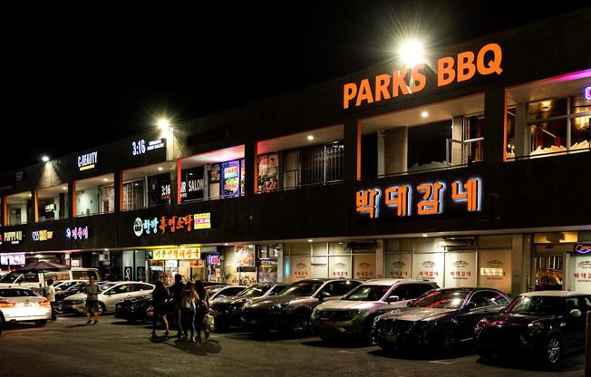 a parking lot in front of a store at night