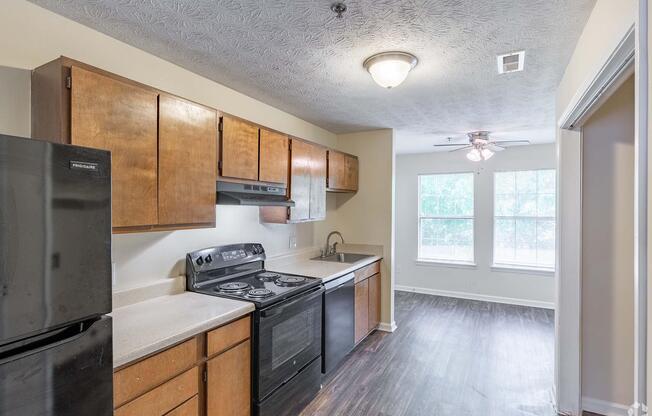 a modern kitchen with stainless steel appliances and wooden cabinets