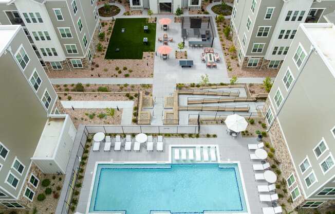 an aerial view of the zeb apartment complex with an outdoor pool and lawn