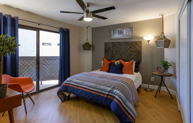 a bedroom with a bed and a ceiling fan