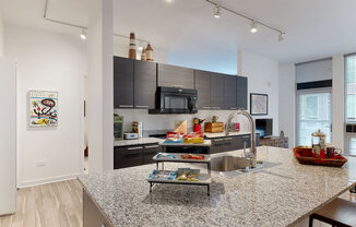 a kitchen with a large island and stainless steel appliances