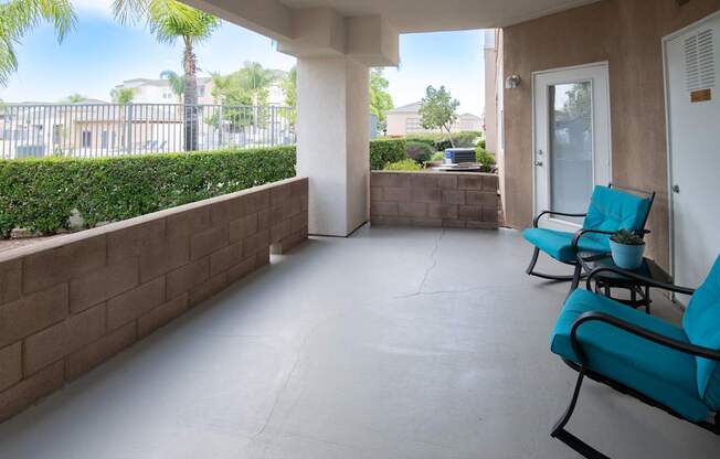A patio with two chairs and a table.