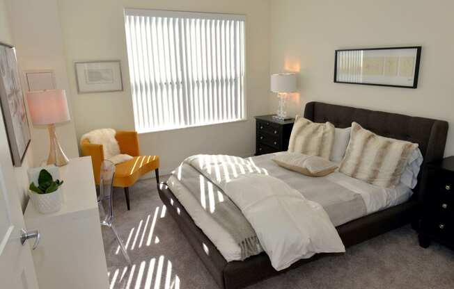 Cozy bed and window at 1500 Nicollet Apartment Homes, Minnesota