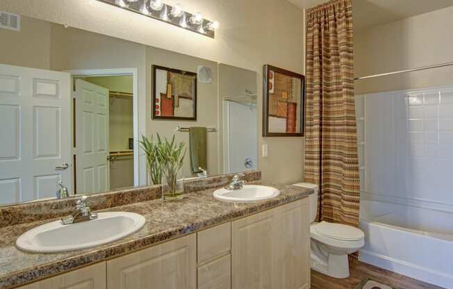 a bathroom with two sinks and a toilet