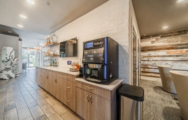 the lobby of a restaurant with a coffee machine on the counter