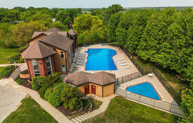 arial view of a house with a large pool in the backyard