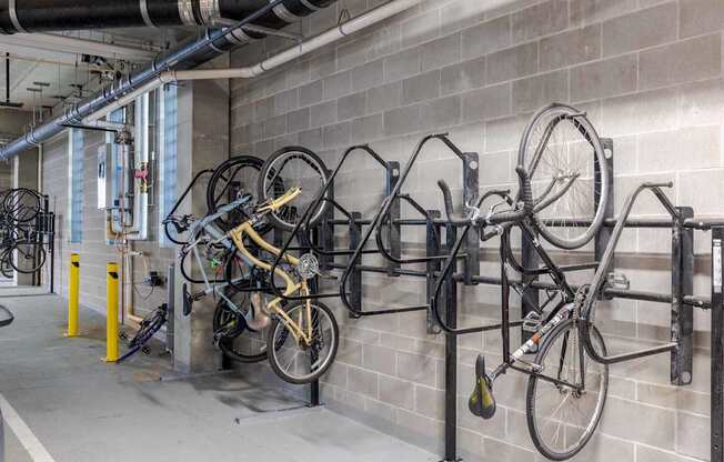 A bike rack with several bicycles parked on it.