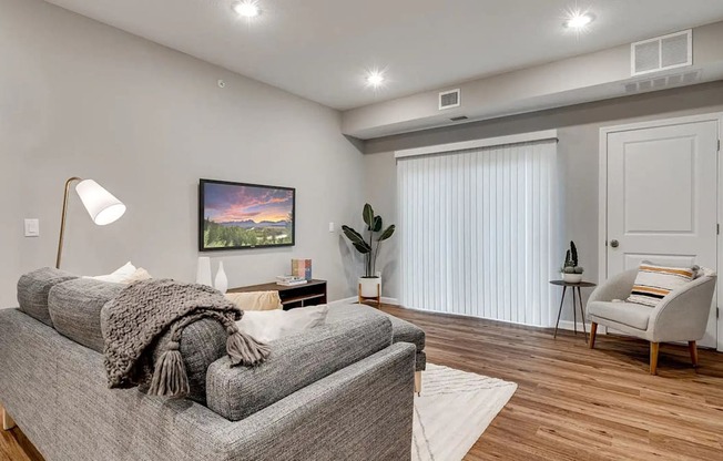 a living room with a couch and a chair. Circle Pines, MN Lexington Lofts