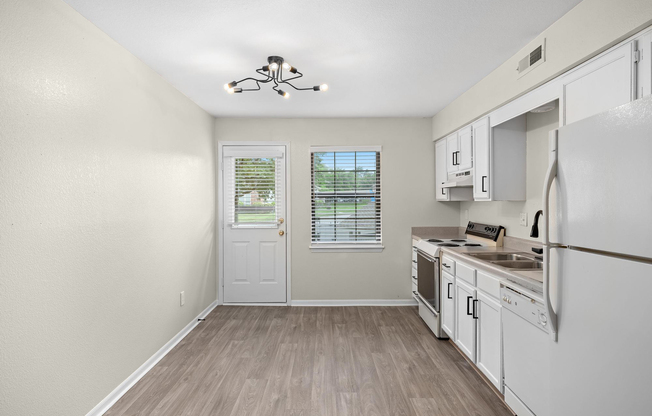 Gold kitchen interior with appliances at The Arbor Apartments in Blue Springs, Missouri