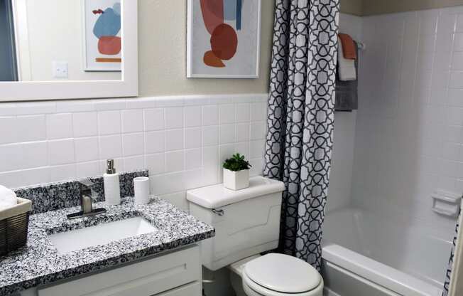 large bathroom with granite vanity, tile, tub, shower, and toilet  at Huntsville Landing Apartments, Huntsville, AL, 35806