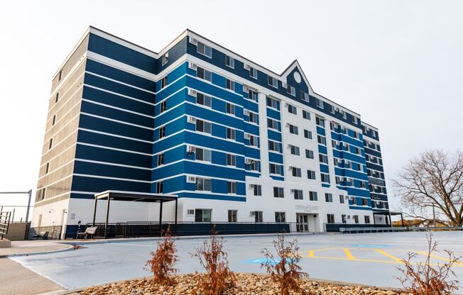 a blue and white building on the corner of a parking lot