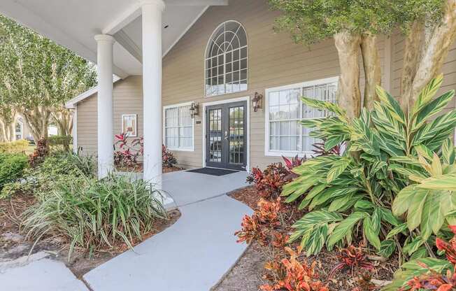 A house with a black door and a white porch.