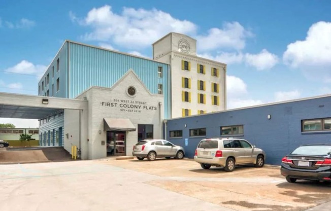 A car dealership with a sign that says "FIRST ON THE MARKET" on the side of the building.