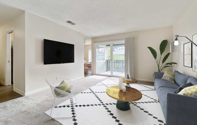 the living room of an apartment with a couch and a coffee table