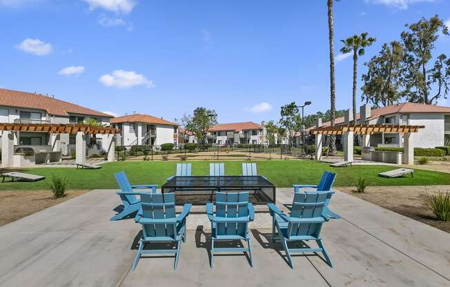 Apartments for Rent Moreno Valley - Ardella on Chagall - BBQ Area with Grilling Stations Under Pergolas, Manicured Grass Lawn, Cornhole Boards, Table and Chairs