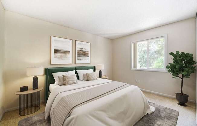 A bedroom with a large bed and a green headboard.