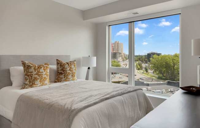a bedroom with a large bed and a large window
