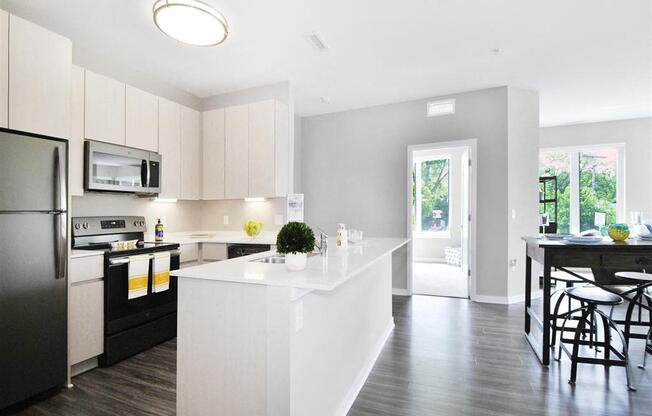 a kitchen with a large white island next to a doorway