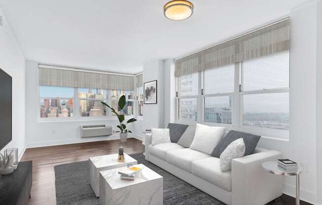 Living room with white couch and table with ceiling light at 65 Bay Street, Jersey City, New Jersey