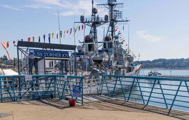 A large ship named USS Turner Joy is docked at a pier at Spyglass Hill Apartments, Bremerton, 98337