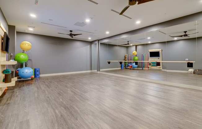 Yoga room with a mirrored wall and a large mirror on top of it