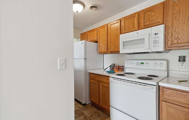 Kitchen with White Appliances and Wood Cabinetry