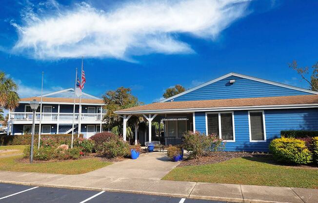 a blue building with a flag and a blue sky