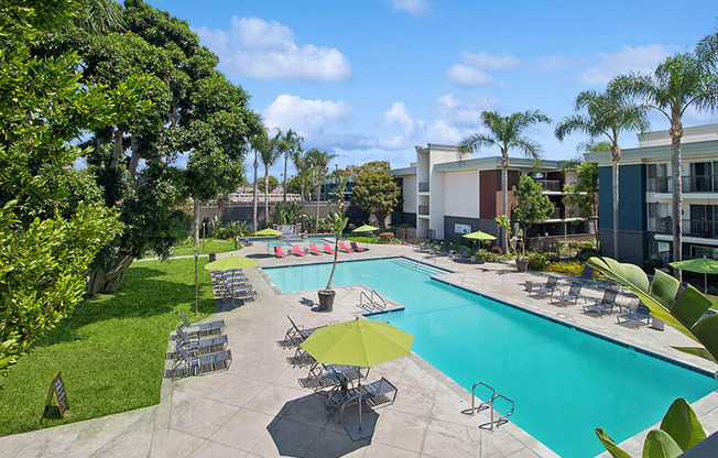 Aerial View of Community Swimming Pool with Pool Furniture at Madison Park Apartments located in Anaheim, CA.