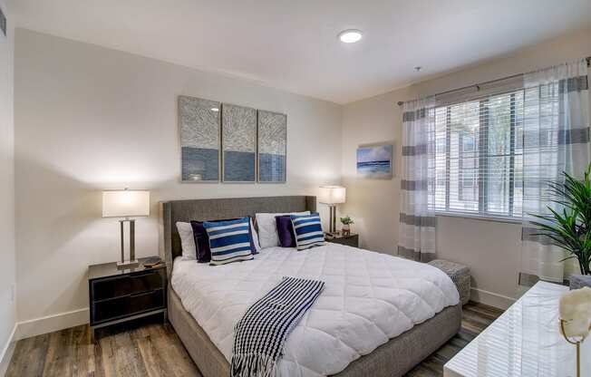 a bedroom with a large bed and a window