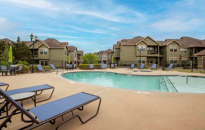 the swimming pool at the whispering winds apartments in pearland, tx