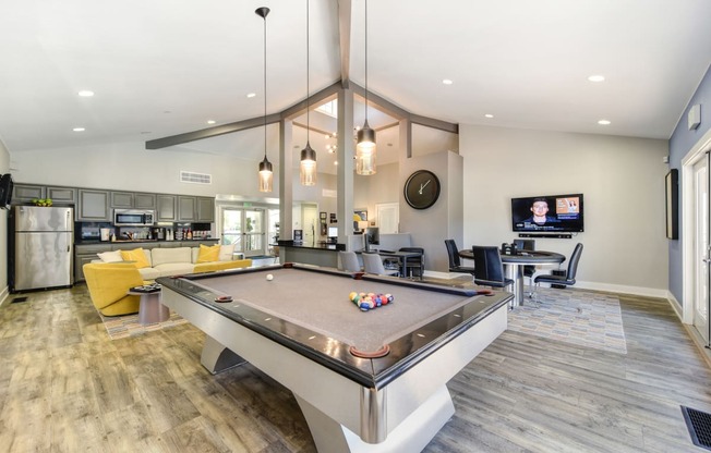 a resident clubhouse with a pool table and a flat screen tv at Renaissance Park Apartments, Davis ,36305