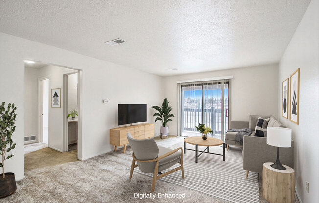 a living room with a couch and a slider to a balcony at Seville Apartments, Kalamazoo, MI, 49009