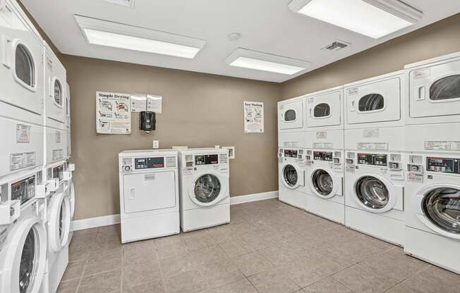 A laundromat with rows of washers and dryers.
