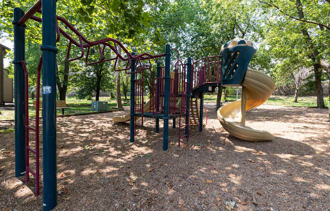 A playground at Skyler Ridge Apartments, featuring swings and a play structure for children to enjoy.